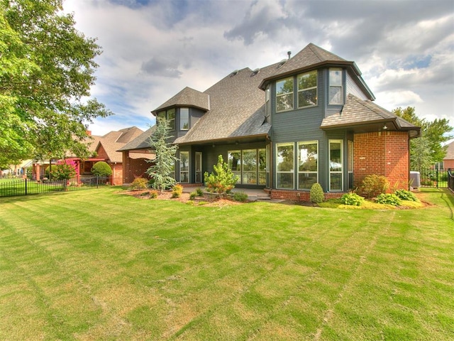 rear view of house with a yard