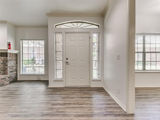 entryway with crown molding and hardwood / wood-style floors