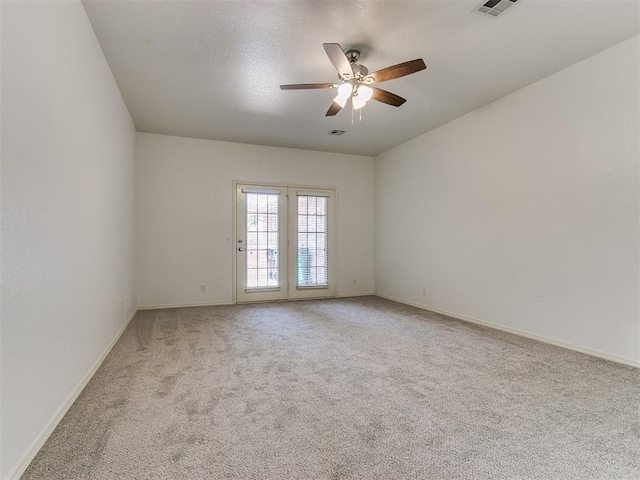 carpeted spare room with ceiling fan