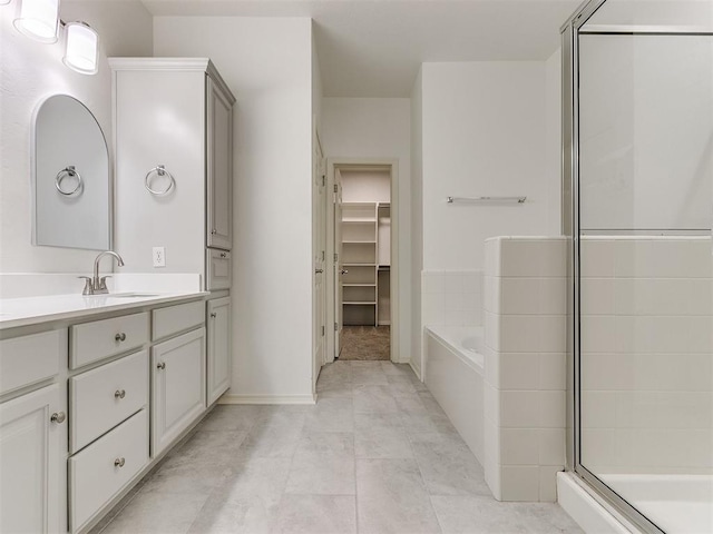 bathroom featuring tile patterned floors, vanity, and separate shower and tub