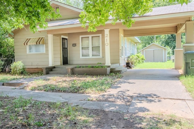 view of front facade featuring a carport and a storage shed