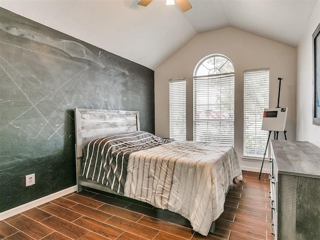 bedroom featuring ceiling fan, dark wood-type flooring, and vaulted ceiling