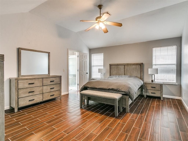 bedroom featuring dark hardwood / wood-style floors, ceiling fan, connected bathroom, and vaulted ceiling