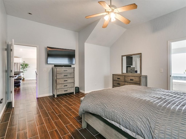 bedroom featuring ceiling fan, dark hardwood / wood-style flooring, ensuite bathroom, and vaulted ceiling