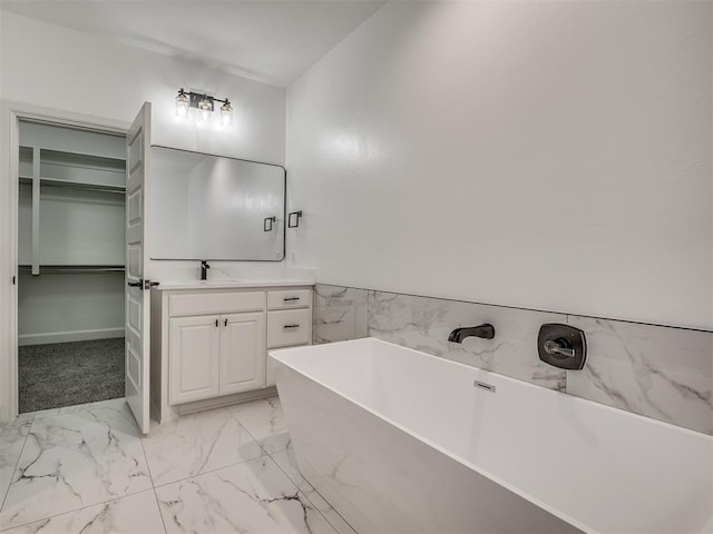 bathroom featuring vanity and a washtub