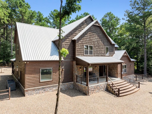 rear view of property with a porch and central AC