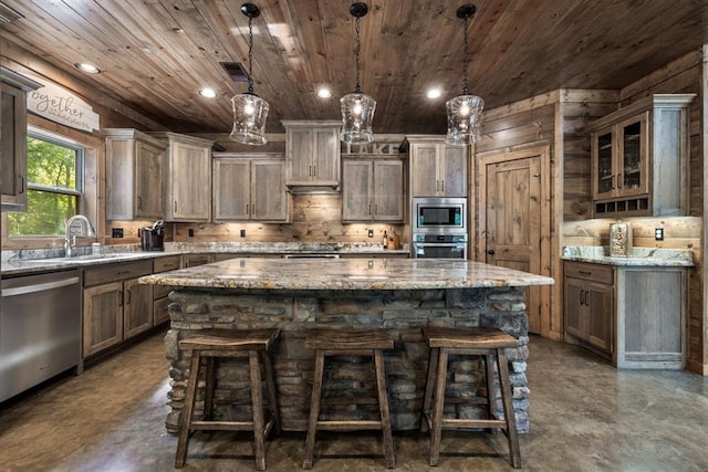 kitchen with appliances with stainless steel finishes, wood ceiling, sink, pendant lighting, and a kitchen island