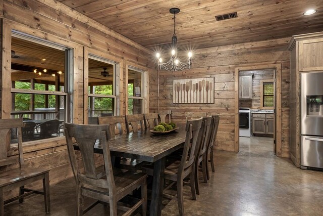 dining space featuring wood walls, wooden ceiling, and a notable chandelier