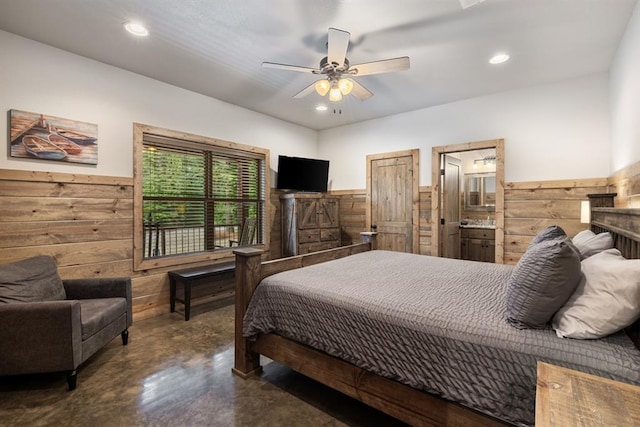 bedroom with ensuite bath, ceiling fan, and wood walls