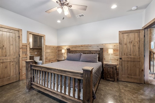 bedroom featuring ceiling fan and wood walls