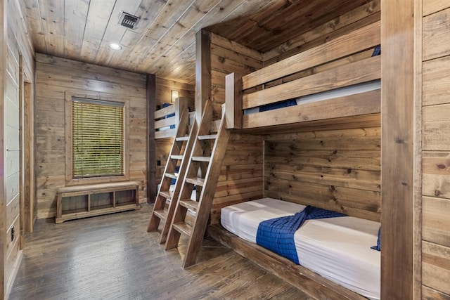 unfurnished bedroom featuring dark hardwood / wood-style floors, wooden ceiling, and wood walls