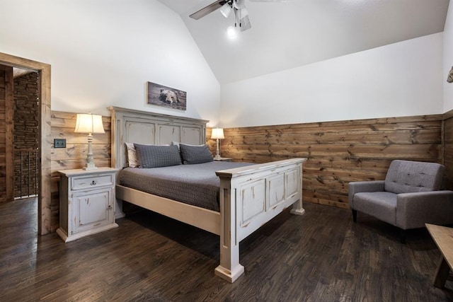 bedroom featuring high vaulted ceiling, ceiling fan, dark hardwood / wood-style flooring, and wooden walls