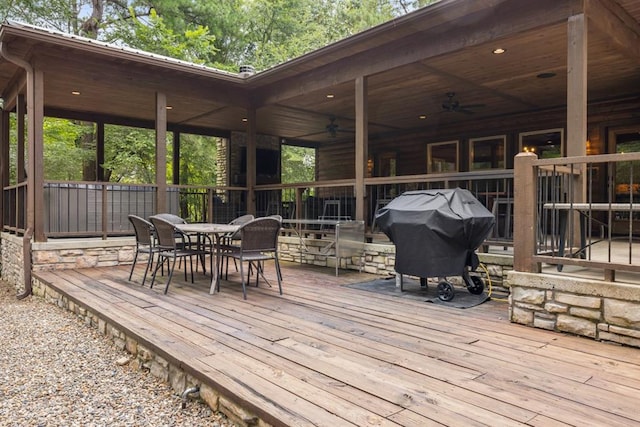 wooden terrace featuring grilling area and ceiling fan