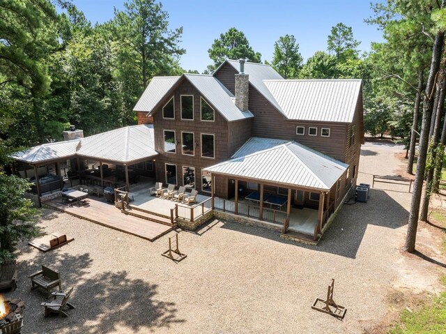 rear view of house featuring central AC unit