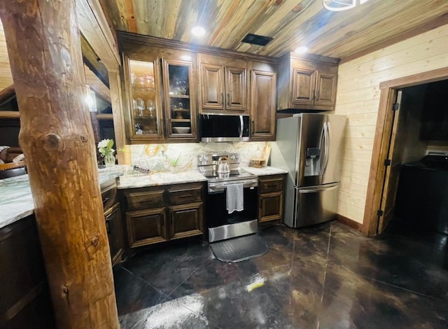 kitchen with dark brown cabinetry, wooden walls, decorative backsplash, wood ceiling, and appliances with stainless steel finishes