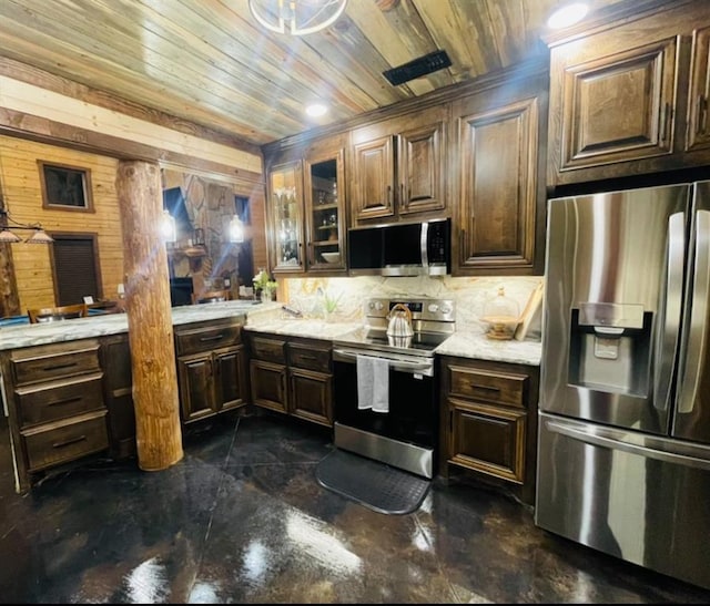 kitchen featuring wood walls, dark brown cabinetry, wooden ceiling, and stainless steel appliances