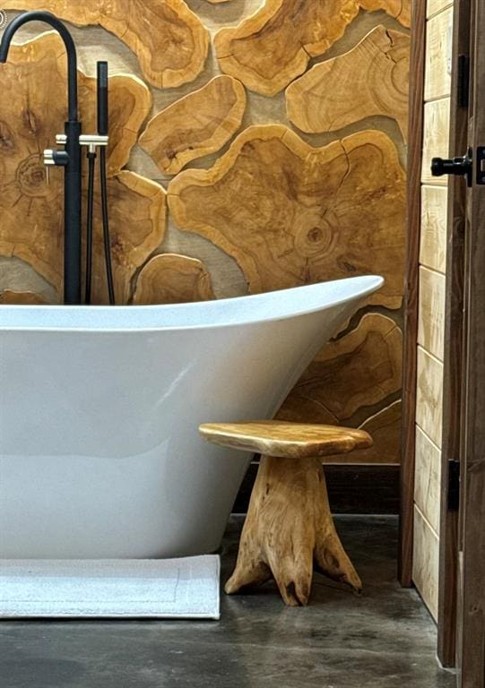 details with a bathing tub and wood-type flooring