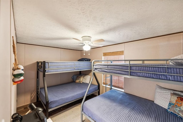 bedroom with a textured ceiling and ceiling fan