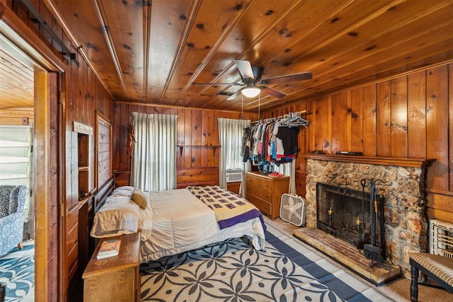 bedroom with wooden ceiling, ceiling fan, and wooden walls