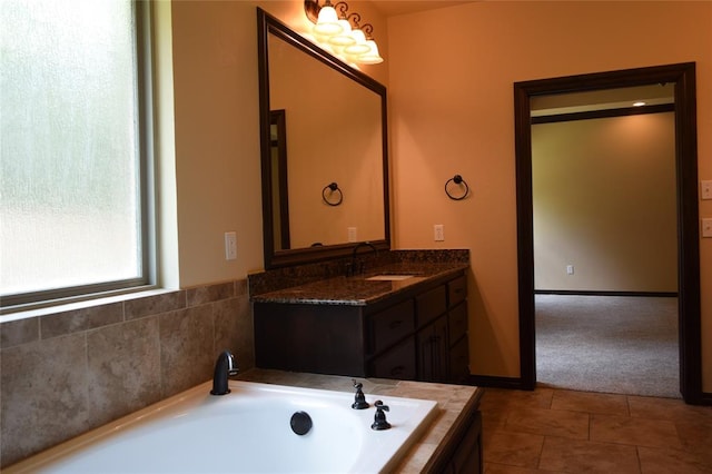 bathroom featuring tile patterned floors, vanity, and a tub