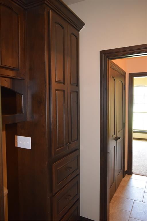 hall with light tile patterned floors