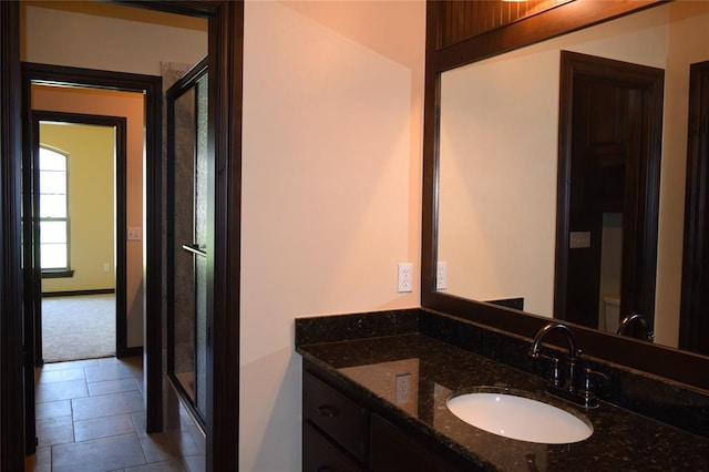 full bathroom featuring tile patterned flooring, vanity, combined bath / shower with glass door, and toilet