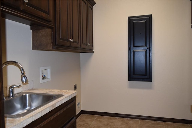 laundry room with sink, cabinets, hookup for an electric dryer, hookup for a washing machine, and light tile patterned floors