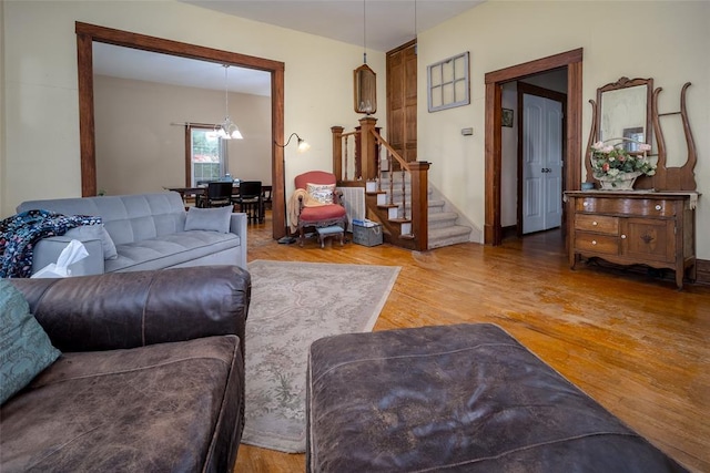 living room featuring hardwood / wood-style flooring and a notable chandelier