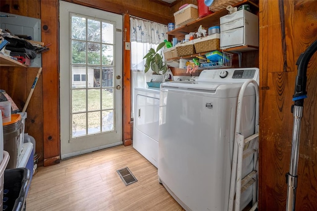 laundry area featuring separate washer and dryer and light wood-type flooring