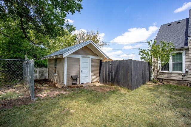 view of outbuilding with a lawn