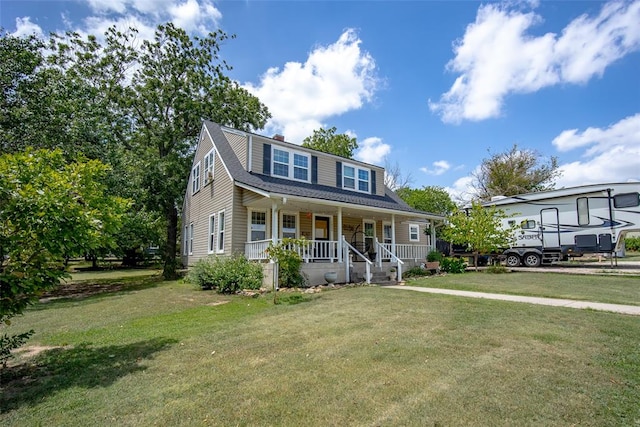 view of front of house with covered porch and a front lawn