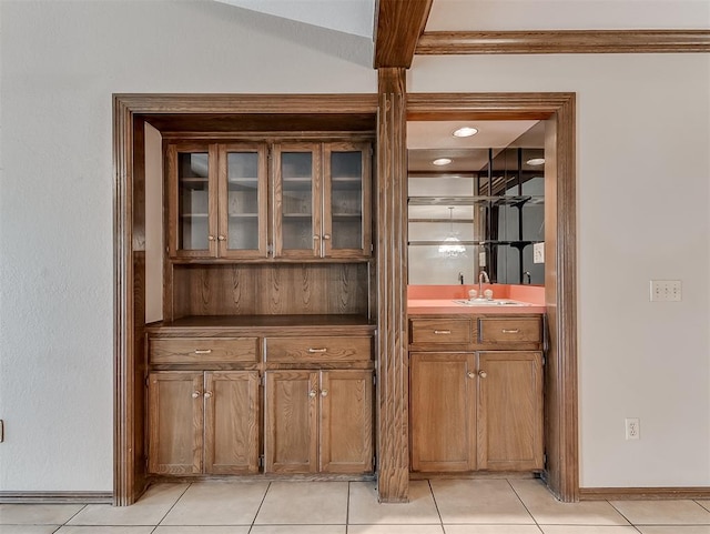 bar featuring sink and light tile patterned floors