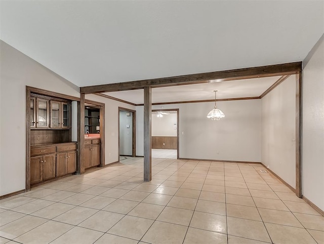 interior space with vaulted ceiling, crown molding, and light tile patterned flooring