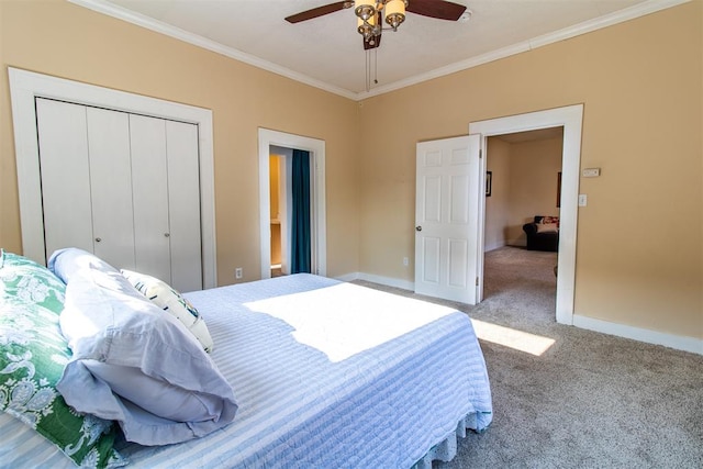 carpeted bedroom featuring ceiling fan, a closet, and ornamental molding