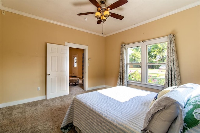 carpeted bedroom with ceiling fan and ornamental molding