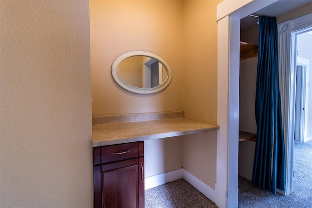 interior space with carpet flooring and built in desk