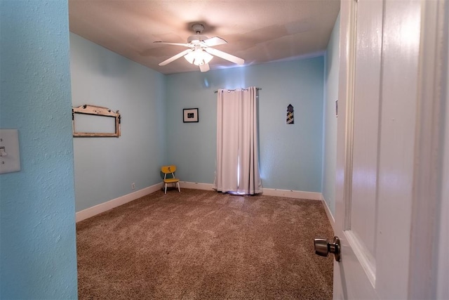 spare room featuring carpet and ceiling fan