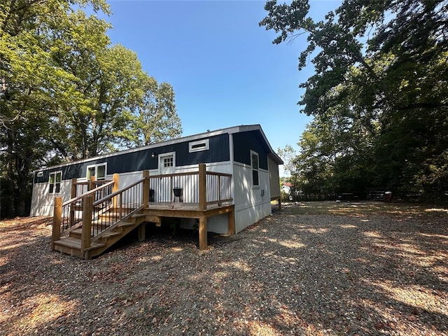 back of house featuring a wooden deck