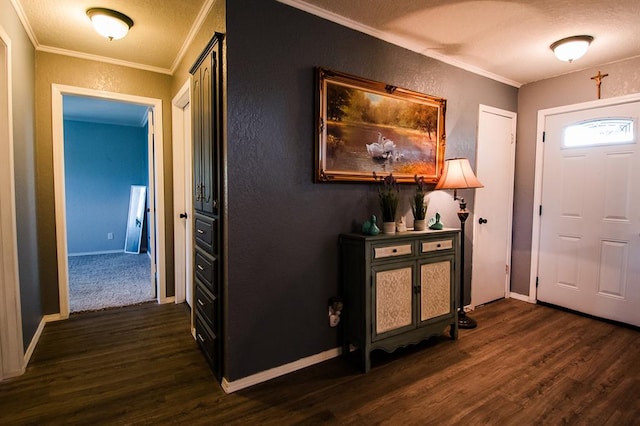 foyer entrance with dark hardwood / wood-style floors, ornamental molding, and a textured ceiling