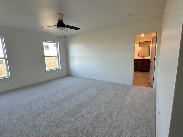 unfurnished room with light carpet and ceiling fan