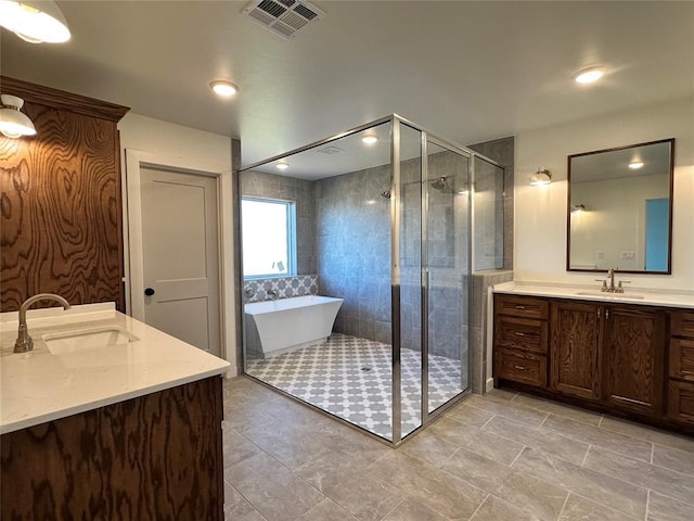 bathroom featuring vanity and separate shower and tub