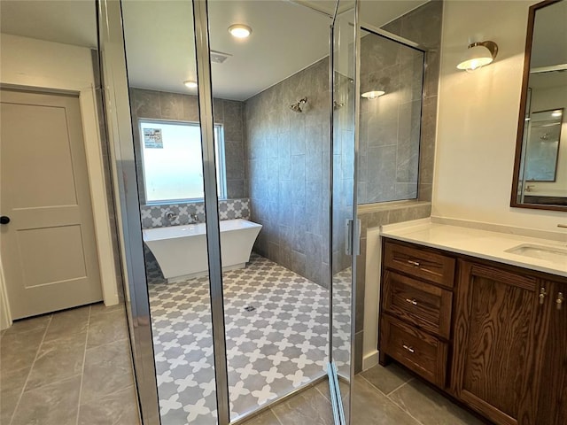 bathroom with vanity, shower with separate bathtub, and tile patterned flooring