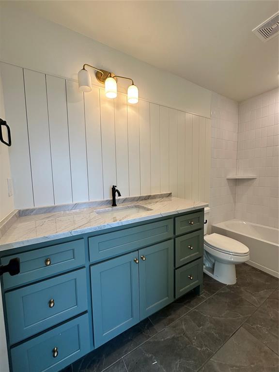 full bathroom with vanity, tub / shower combination, and toilet