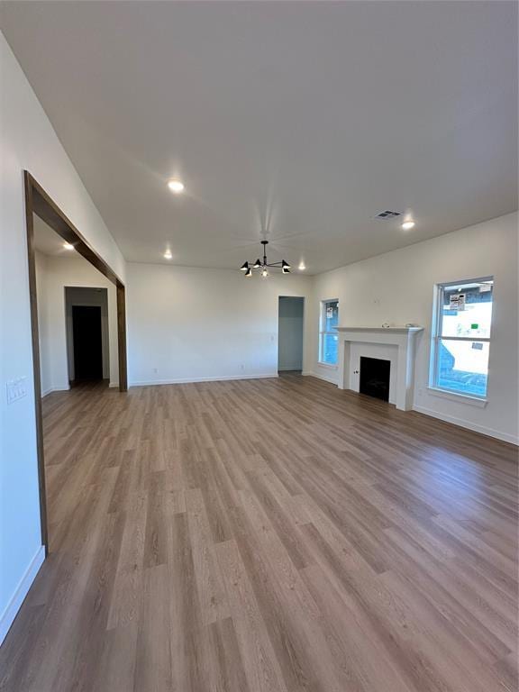 unfurnished living room with light hardwood / wood-style flooring