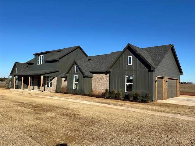 modern inspired farmhouse with covered porch and a garage