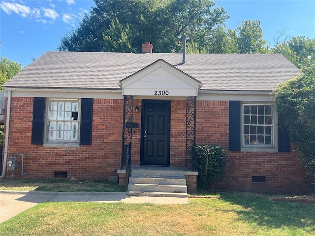 bungalow-style home with a front lawn