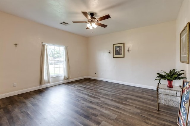 spare room featuring ceiling fan and dark hardwood / wood-style floors