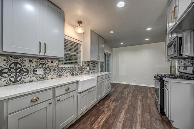 kitchen with dark hardwood / wood-style flooring, sink, gray cabinets, and appliances with stainless steel finishes