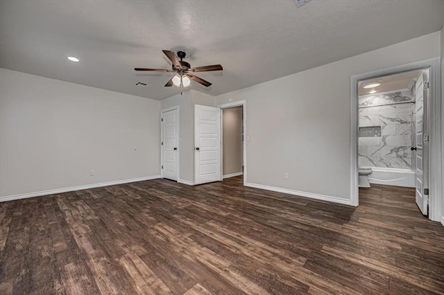 unfurnished bedroom featuring ensuite bathroom, ceiling fan, and dark hardwood / wood-style floors