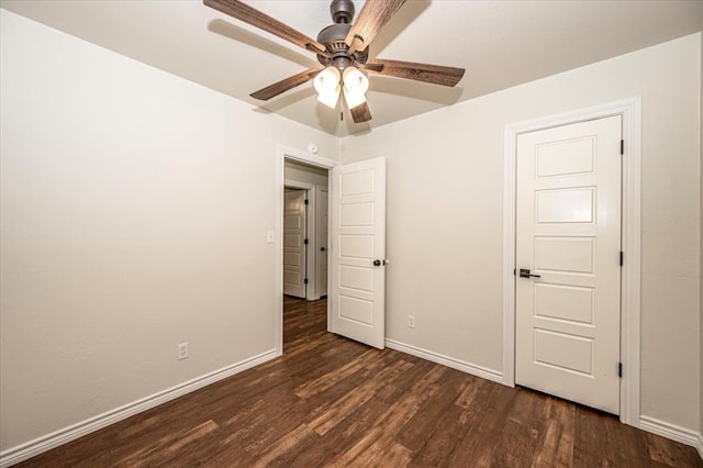 unfurnished bedroom with ceiling fan and dark hardwood / wood-style floors